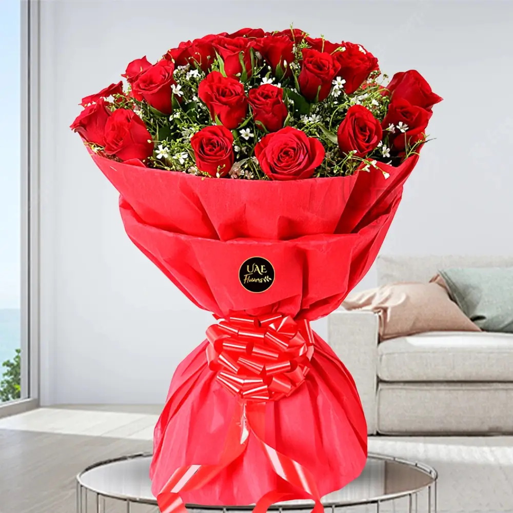 25 red roses with green fillers wrapped in red paper and tied with red ribbon