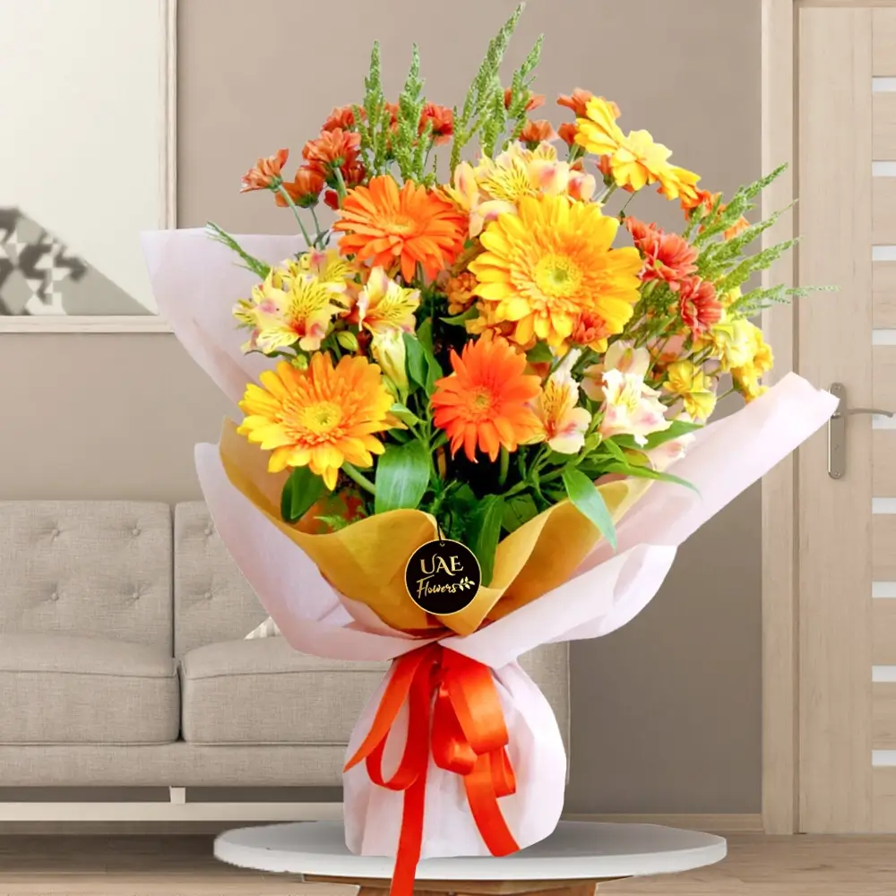 bouquet with 3 orange, 3 yellow gerberas, chrysanthemums, alstroemeria, and fillers in wrapping.