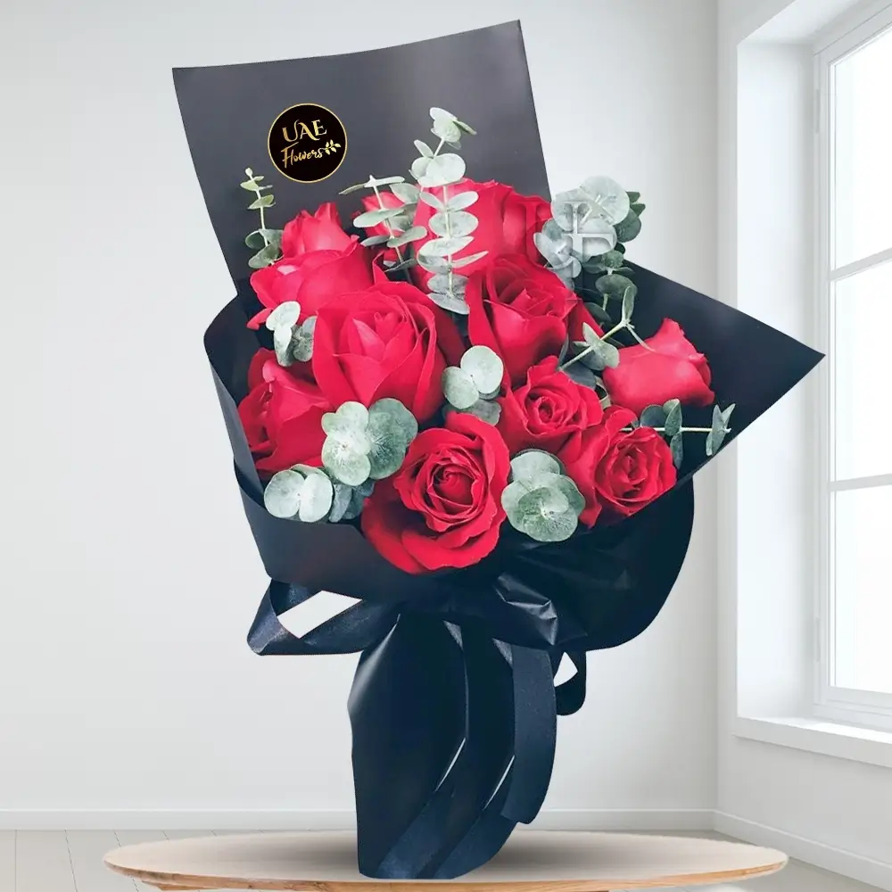 12 red roses with eucalyptus