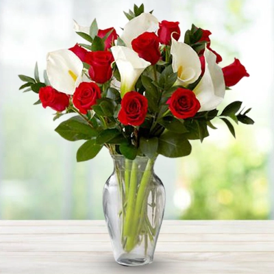 12 red rose and 6 white calla lilies with greens fillers in a vase 12 red rose and 6 white calla lilies with greens fillers in a vase