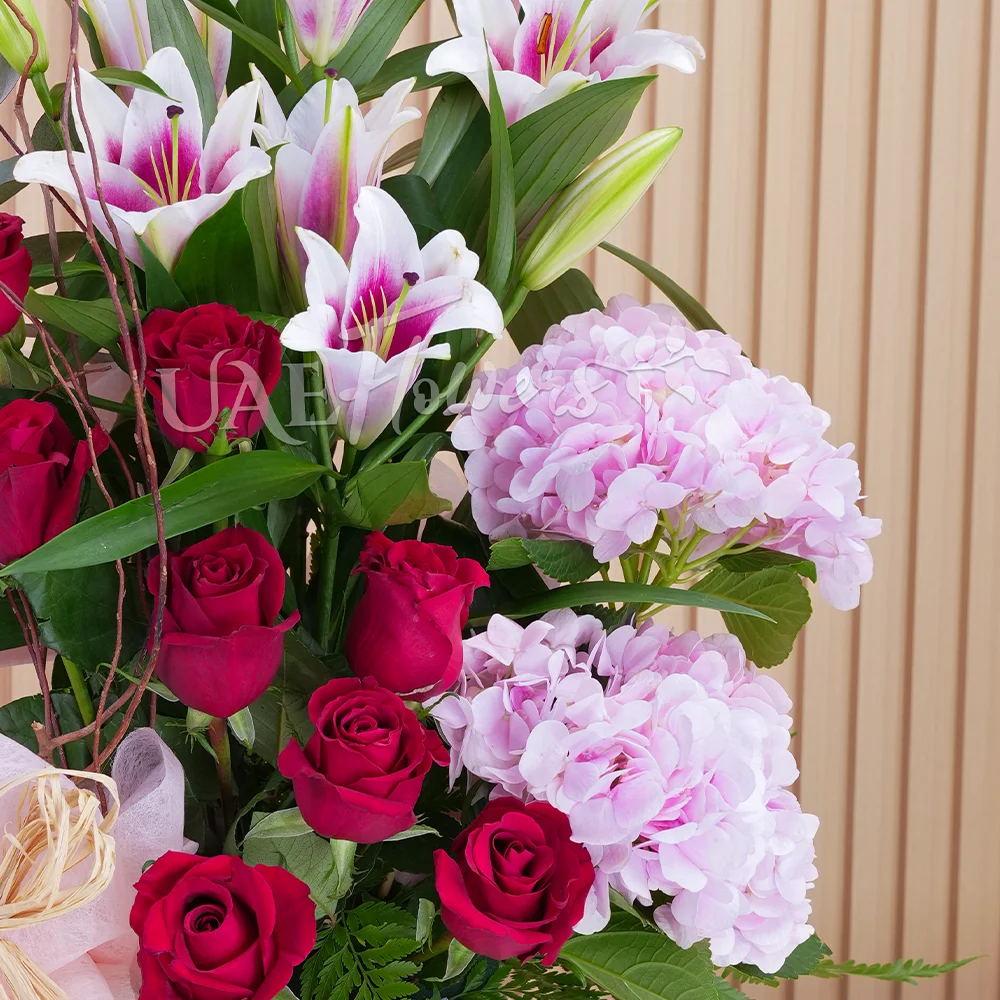 2 pink hydrangeas, 2 pink lilies, and 8 red roses