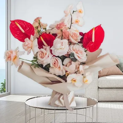 A bouquet containing 3 red anthuriums, 10 peach roses, and 3 lisianthus double alissa champagne, along with green leaves. The bouquet is wrapped in brown paper and tied with a brown ribbon
