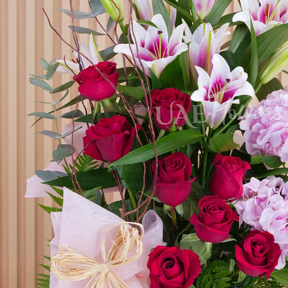 2 pink hydrangeas, 2 pink lilies, and 8 red roses