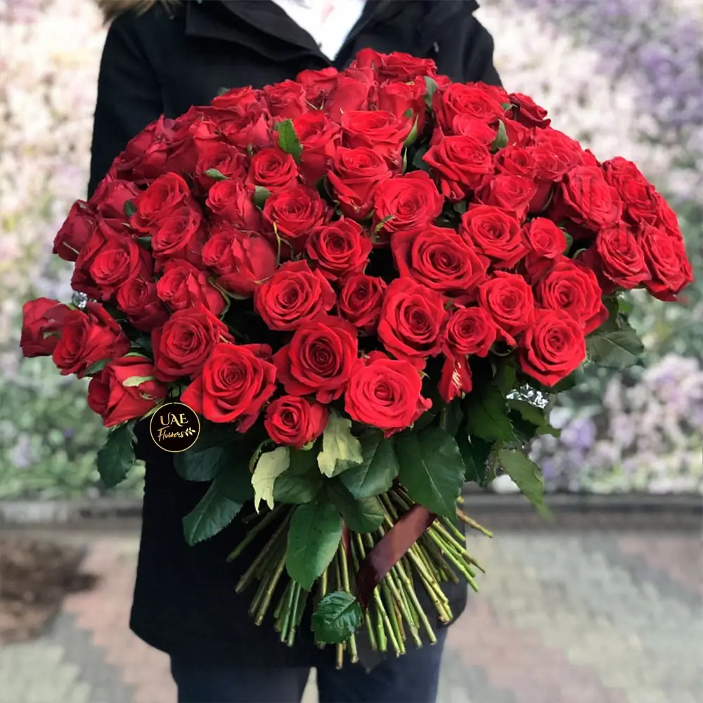 A bouquet of 40 red roses tied with brown ribbon