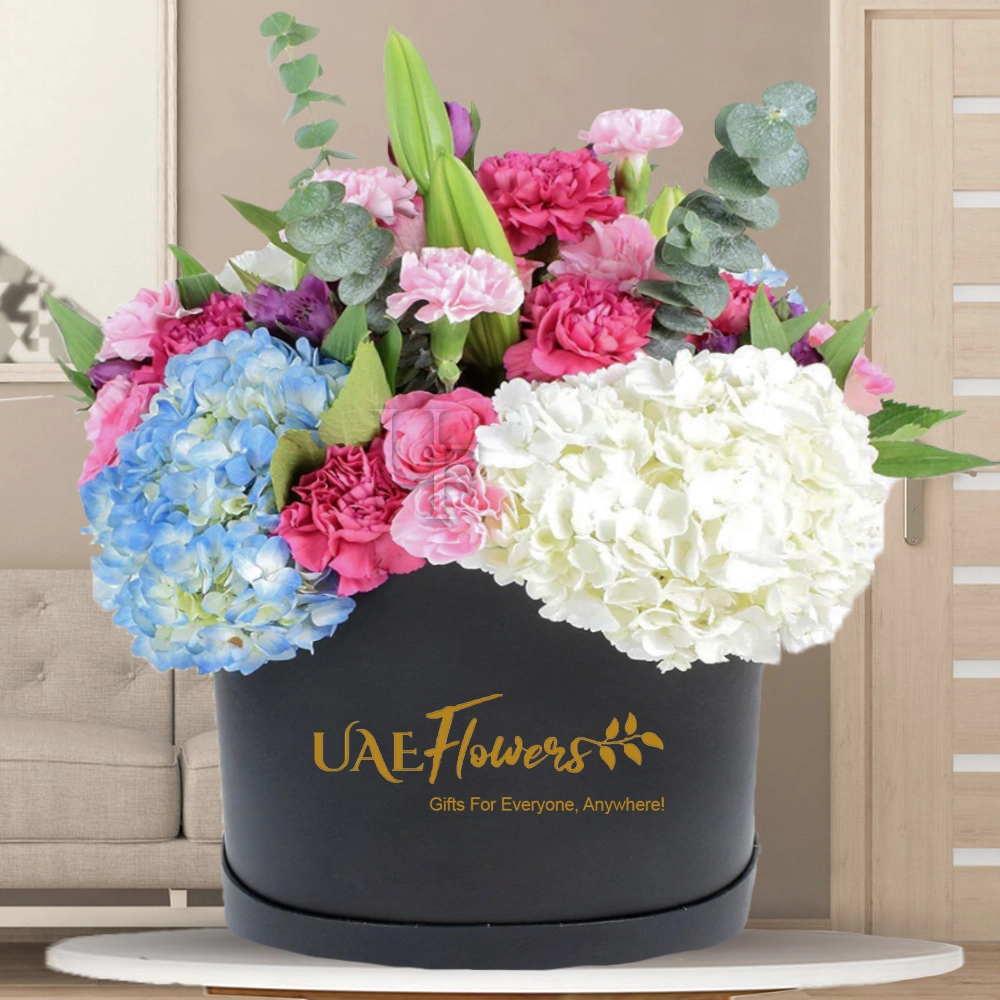 2 stems of white and blue hydrangeas, 1 white lily stem, and 10 pink carnations