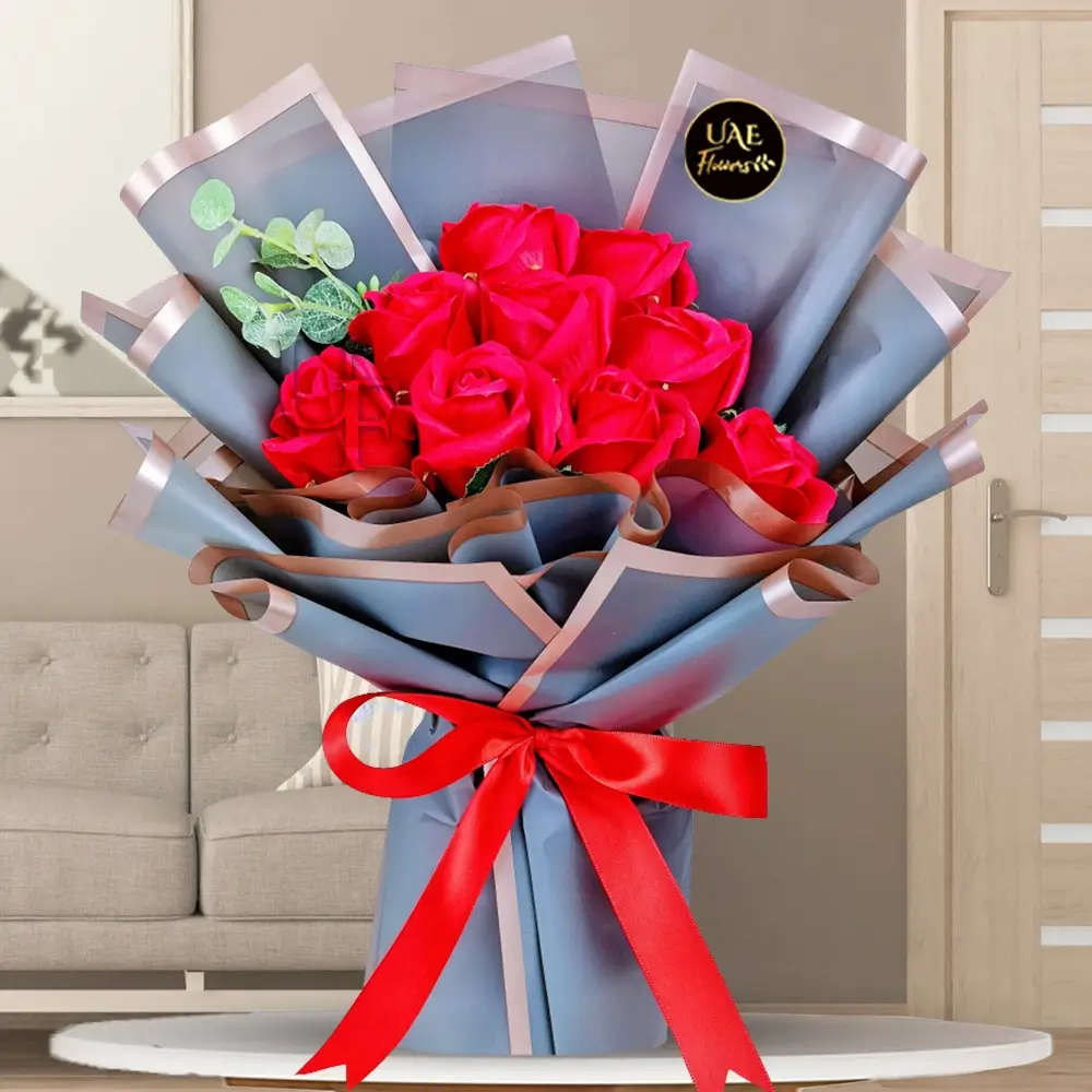 Red roses bouquet wrapped in elegant paper for gifting