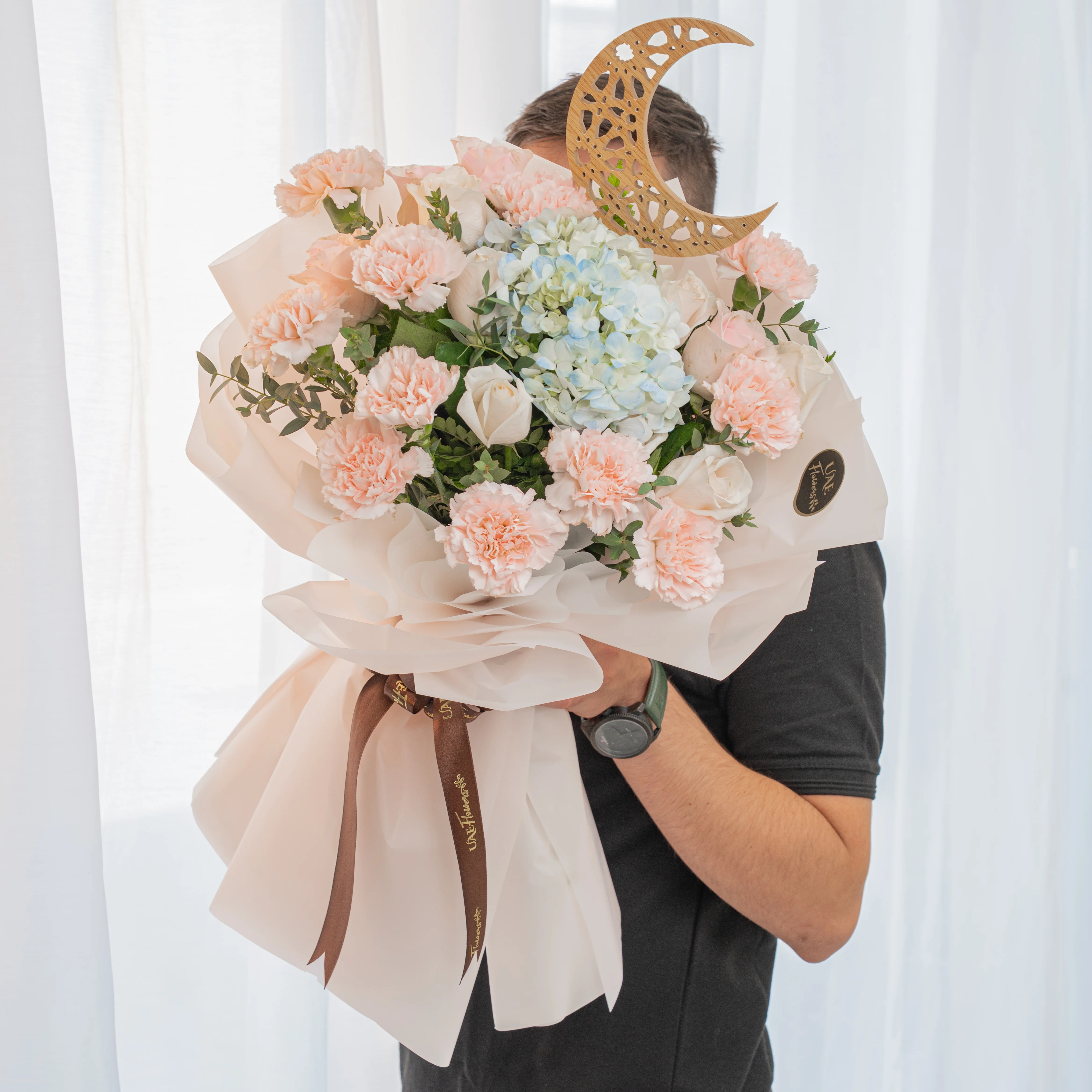 pink carnations, white roses and blue hydrangea bouquet