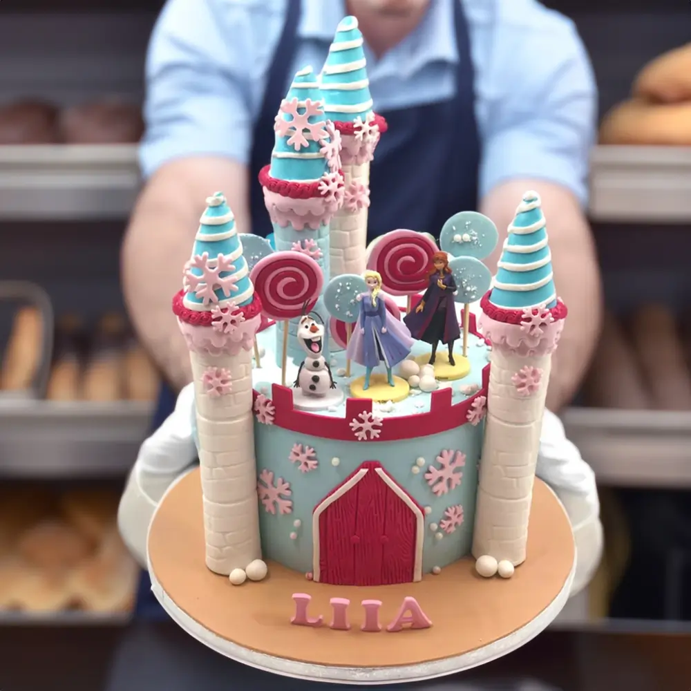Frozen Land Castle Cake with Elsa, Anna, and Olaf toppers for kids’ birthday.