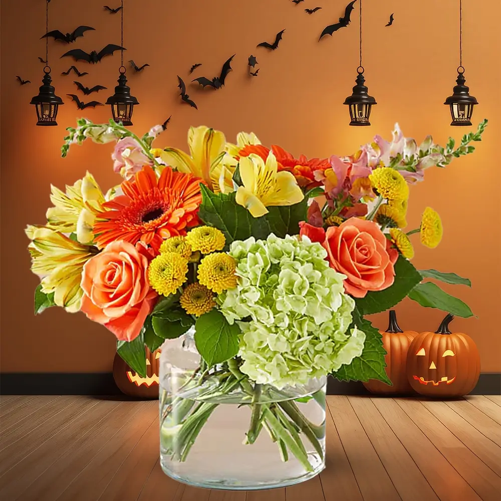 3 red gerberas, 3 orange roses, 2 yellow button chrysanthemums, 2 yellow alstroemeria, 1 green hydrangea, and fillers in a glass vase