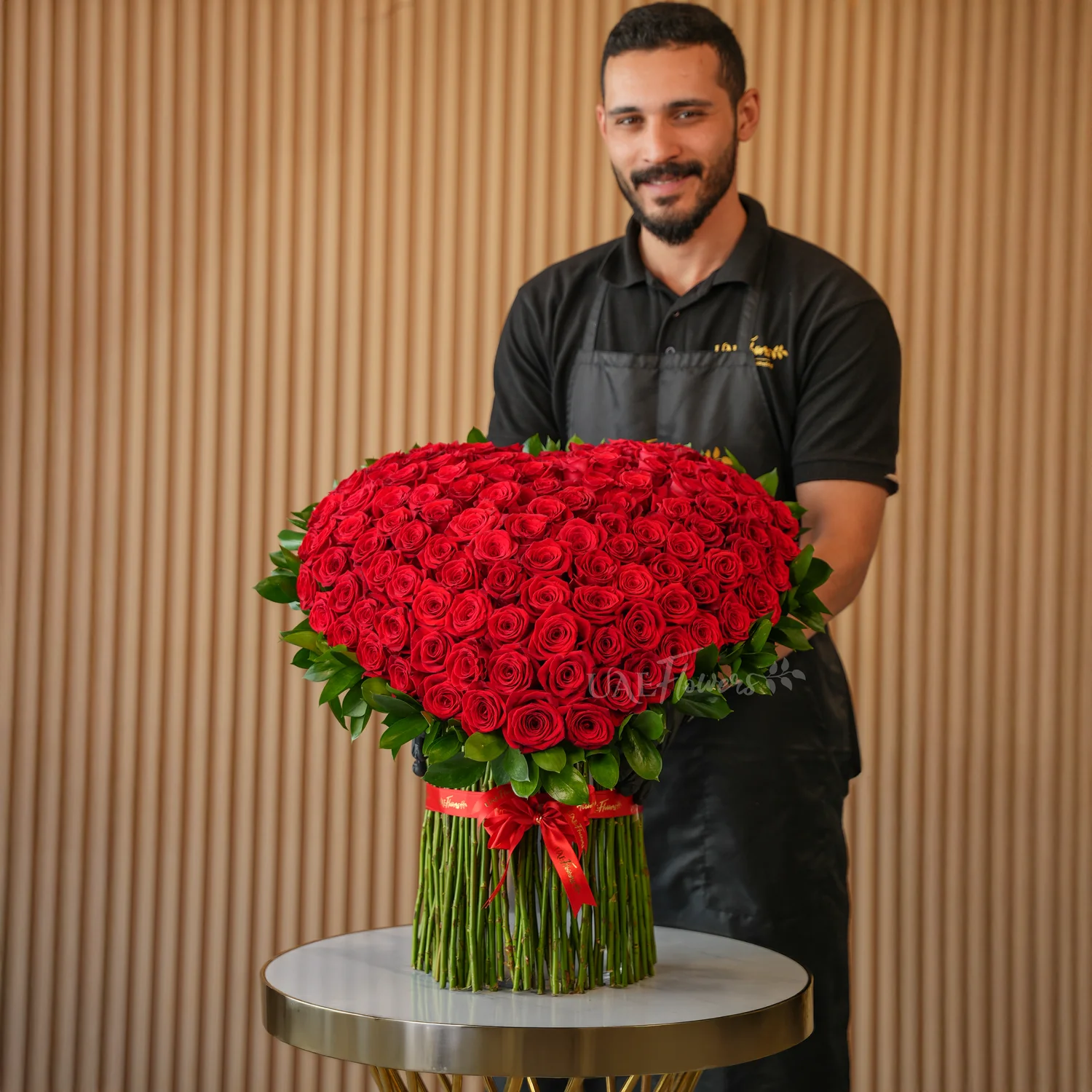 heart-shaped standing arrangement with 120 red roses