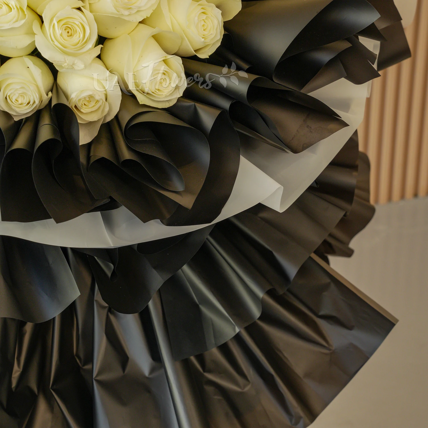 bouquet with 60 red and 60 white roses wrapped in black and white paper packing