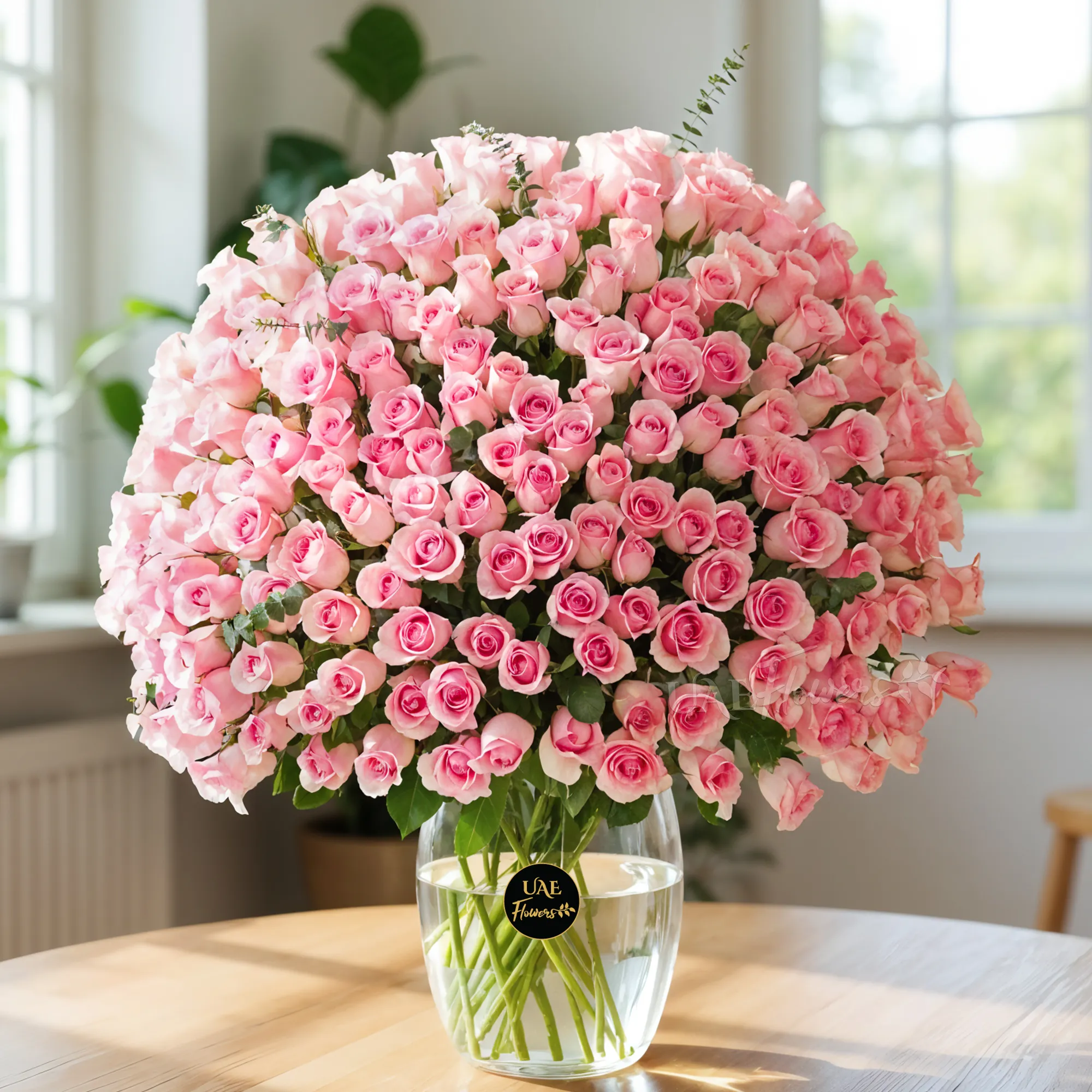 Elegant vase filled with 200 vibrant pink roses and lush green fillers, perfect for grand celebrations.