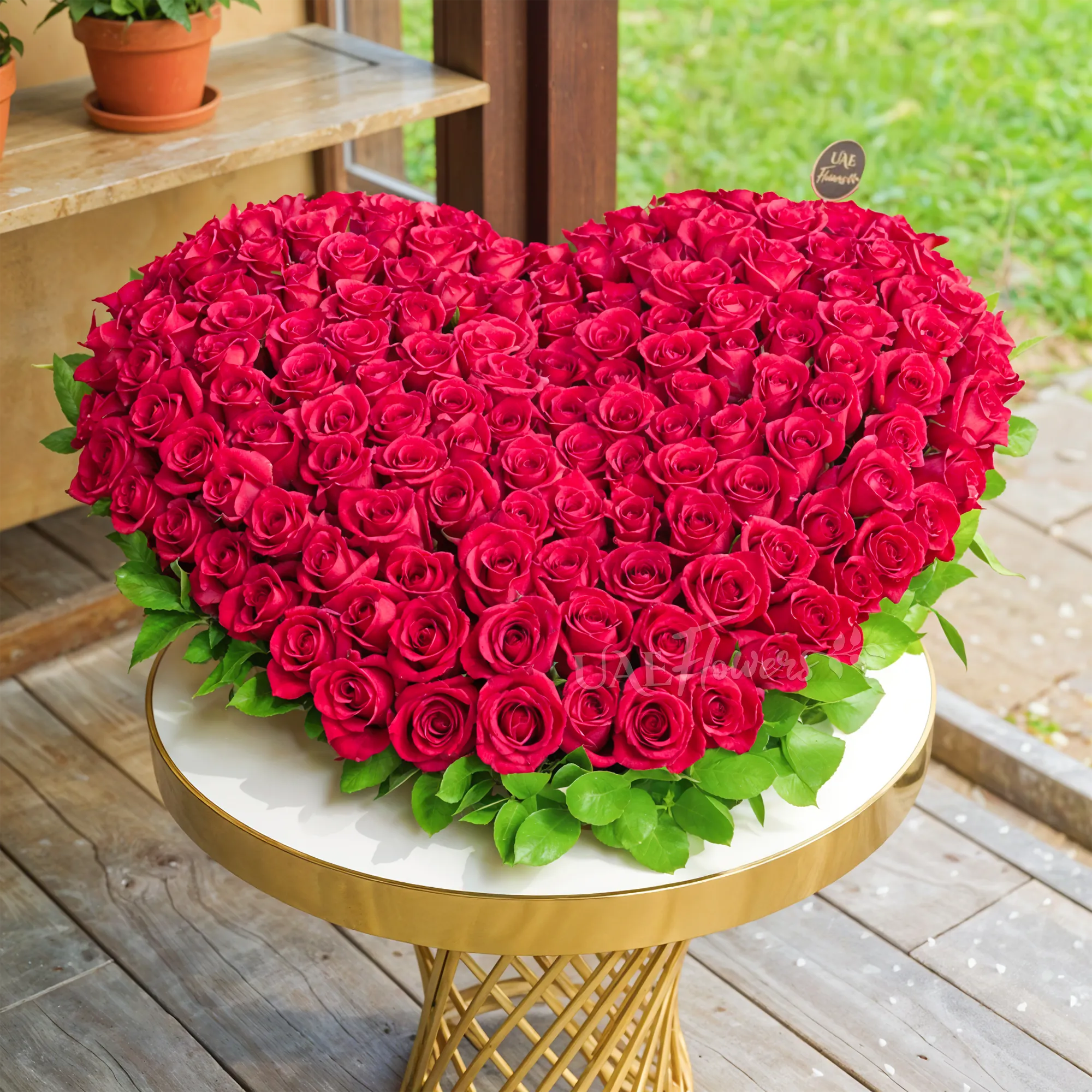 Heart-shaped arrangement of 100 red roses with delicate fillers, symbolizing love and romance.