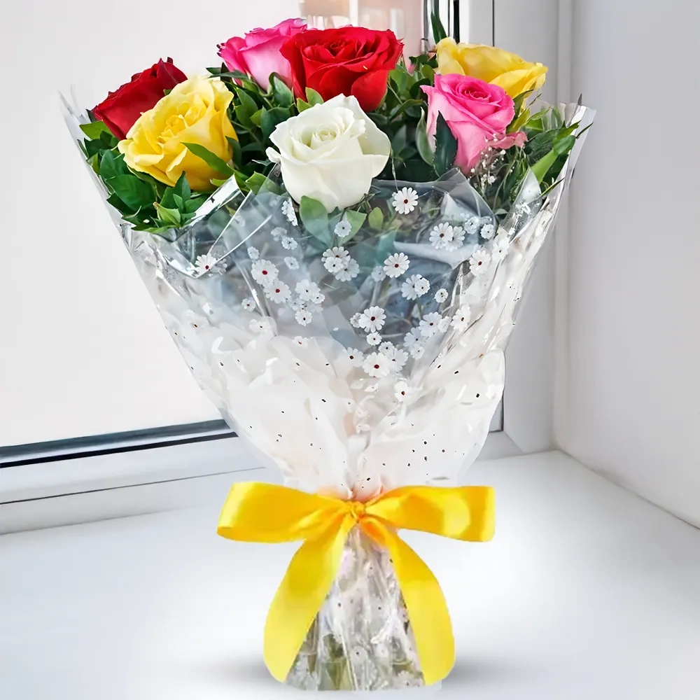 Colorful bouquet of 8 mixed roses including red, pink, white, and yellow, arranged with fillers and wrapped in clear floral cellophane with a yellow ribbon.