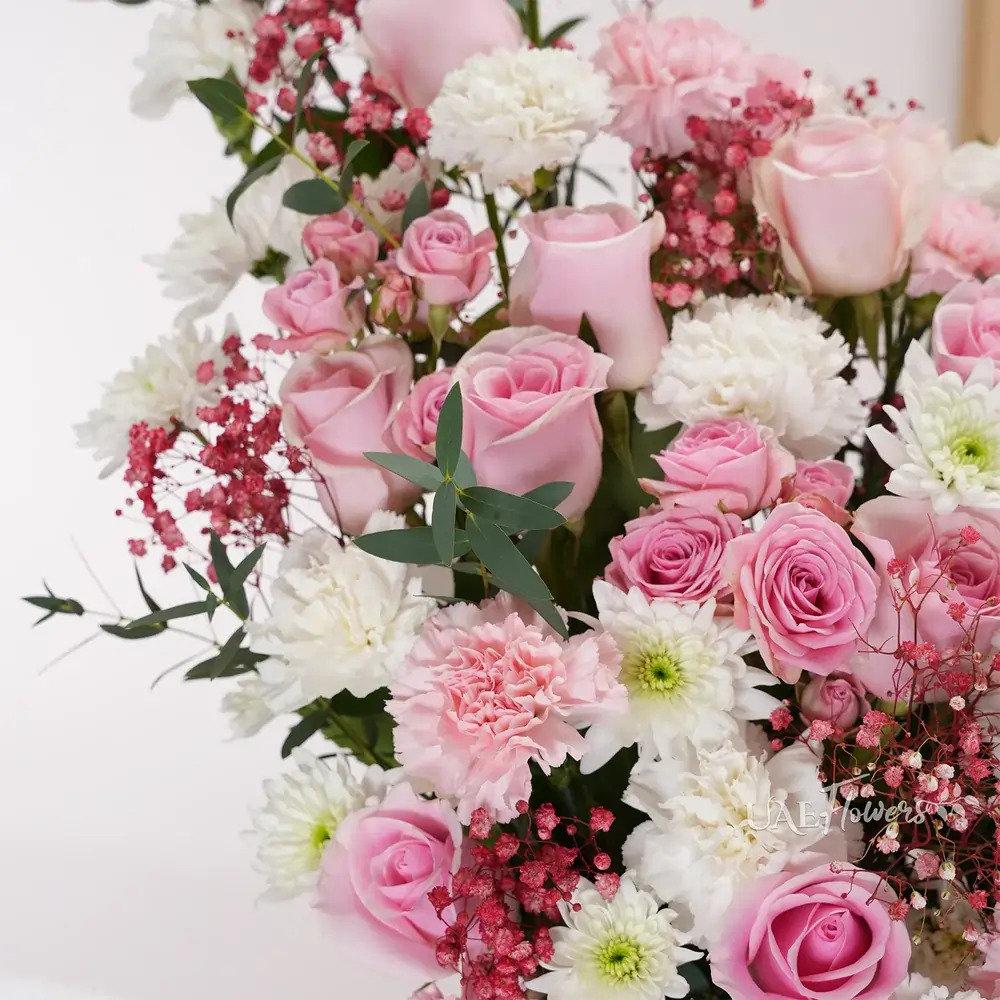 15 pink roses, 12 pink and white carnations, 5 pink spray roses,