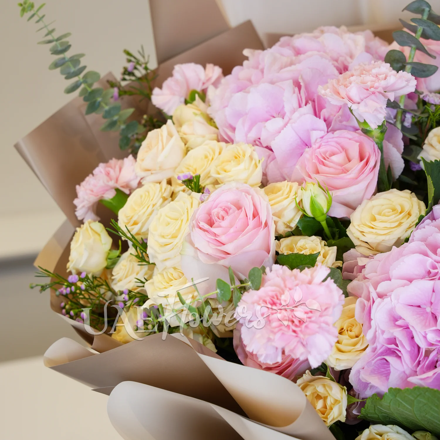 bouquet of 3 pink hydrangeas, 6 pink carnations, 6 pink roses, and 5 peach spray roses