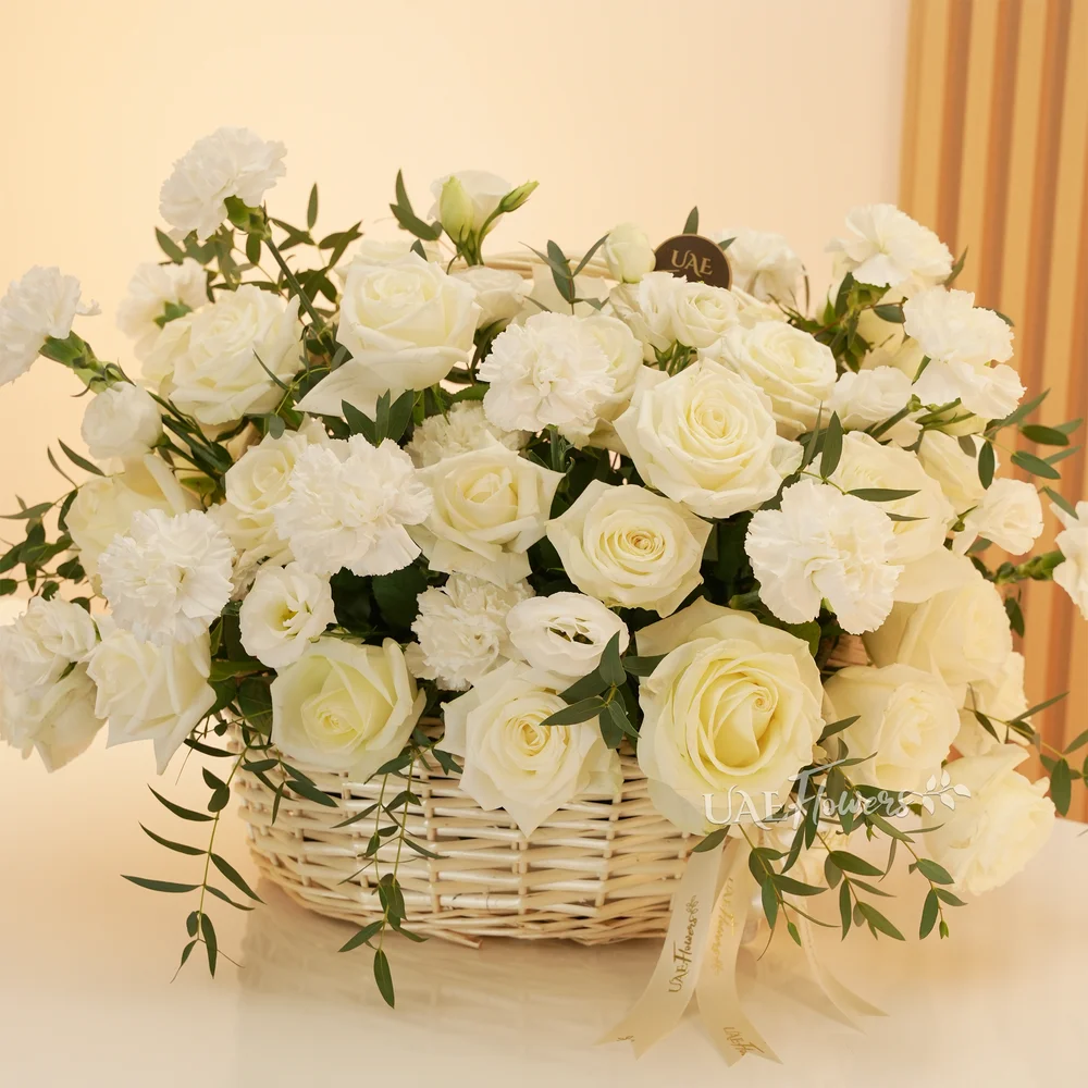 basket arrangement of 15 white carnations and 15 white roses and fillers